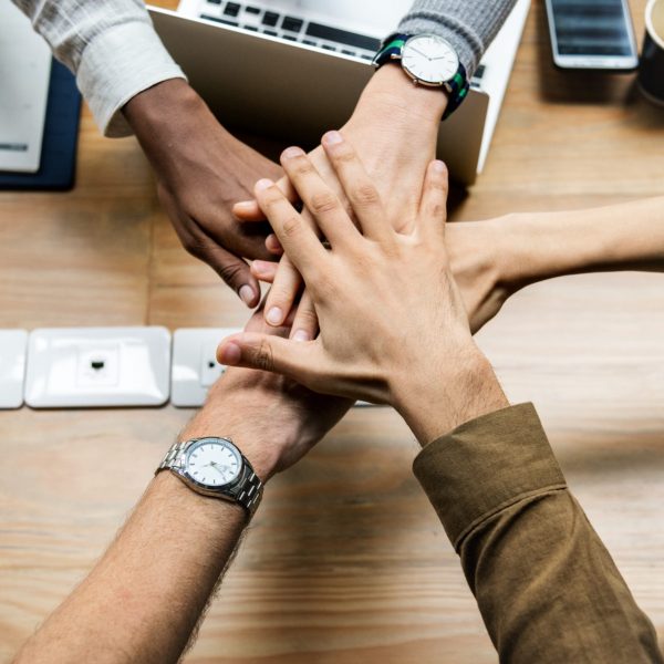 Team of business people stacking hands